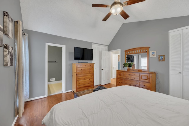 bedroom featuring lofted ceiling, hardwood / wood-style floors, a closet, and ceiling fan