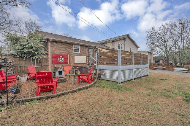 back of property featuring a lawn