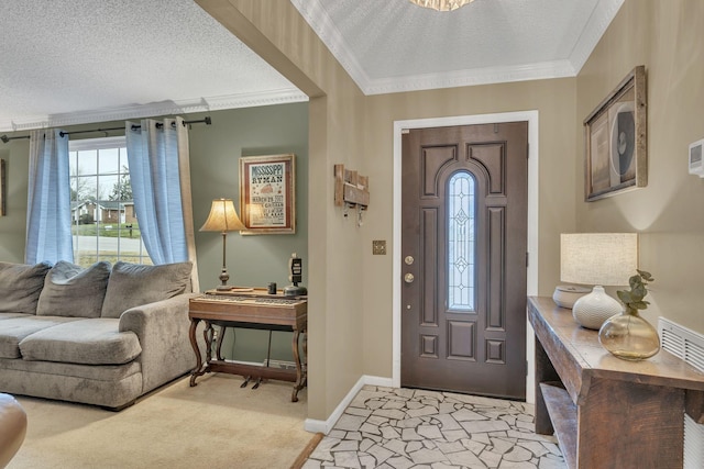 carpeted foyer entrance with a textured ceiling and ornamental molding