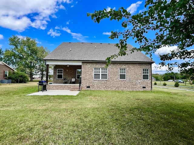 rear view of house featuring a patio, central AC unit, and a yard