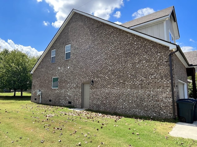 view of side of property with a garage and a lawn