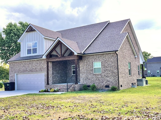 view of front of property with a garage, cooling unit, and a front yard