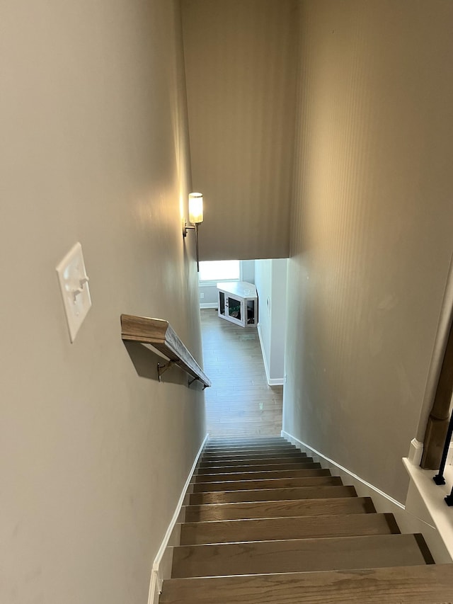 stairs featuring wood-type flooring