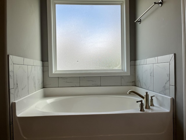 bathroom featuring a bathtub and a wealth of natural light