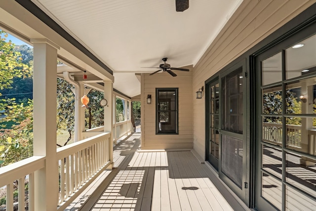 wooden terrace featuring ceiling fan