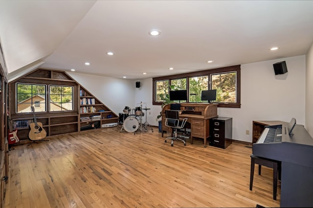 office featuring lofted ceiling and light wood-type flooring