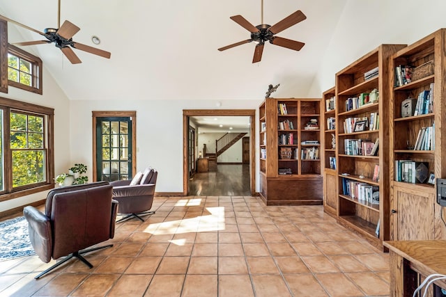 sitting room with high vaulted ceiling, light tile patterned floors, and ceiling fan