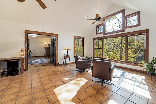 tiled living room featuring high vaulted ceiling and ceiling fan