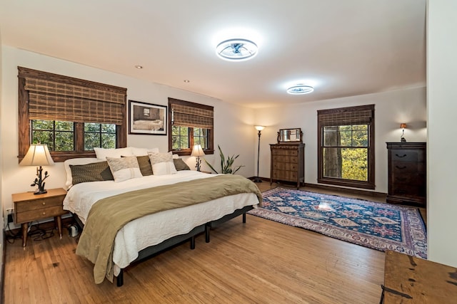 bedroom featuring hardwood / wood-style flooring and multiple windows