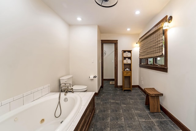 bathroom with toilet and tiled tub