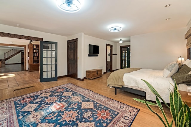 bedroom with light hardwood / wood-style floors, a closet, and french doors