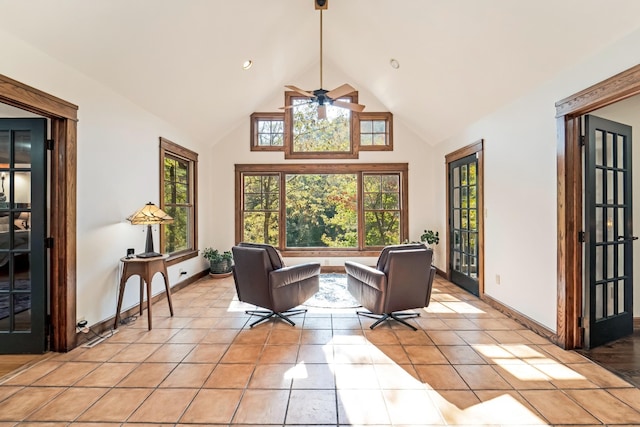 tiled living room with ceiling fan, high vaulted ceiling, and a wealth of natural light