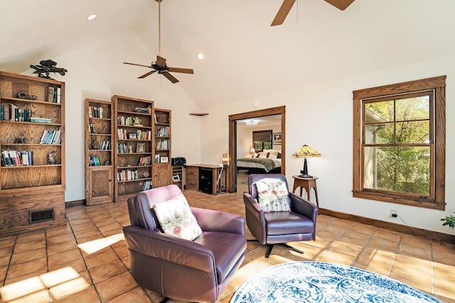 tiled living room featuring ceiling fan and high vaulted ceiling