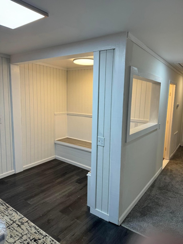 hallway featuring dark hardwood / wood-style flooring and crown molding