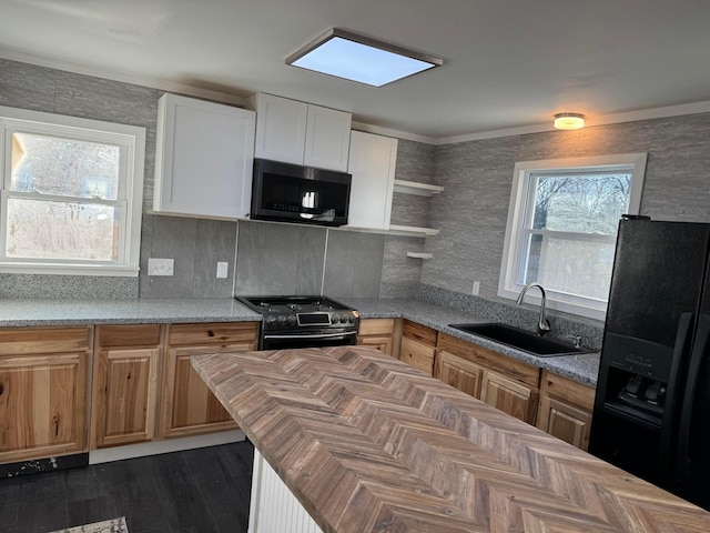 kitchen with sink, white cabinetry, range, ornamental molding, and black refrigerator with ice dispenser