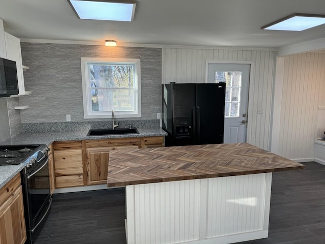 kitchen featuring sink, black appliances, and butcher block countertops