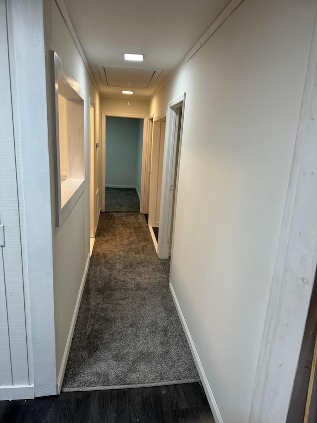 hall featuring crown molding and dark colored carpet