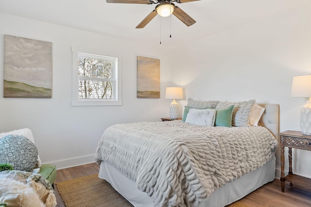 bedroom with wood-type flooring and ceiling fan