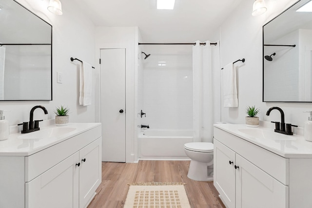 full bathroom with shower / bath combo, wood-type flooring, vanity, and toilet