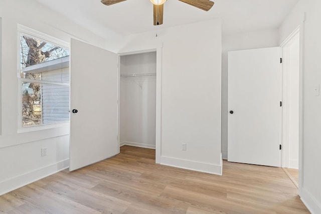 unfurnished bedroom with light hardwood / wood-style flooring, a closet, and ceiling fan