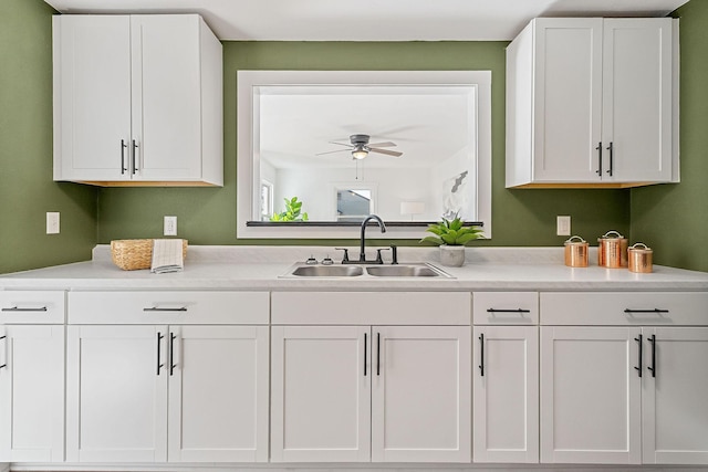 kitchen with white cabinetry, ceiling fan, and sink