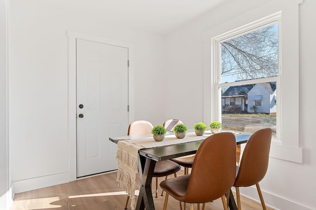 dining space with light hardwood / wood-style flooring