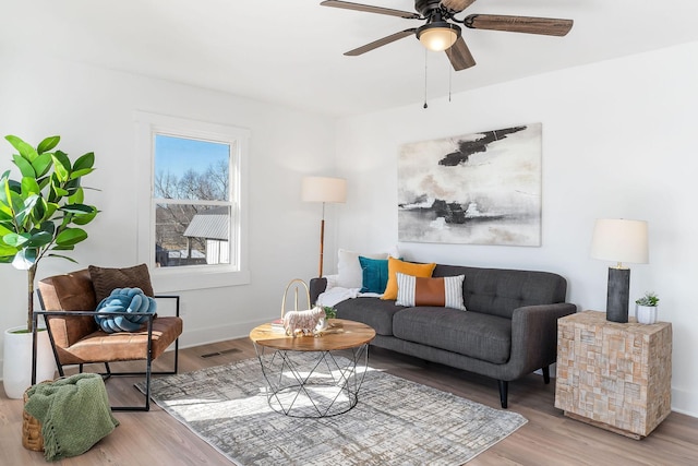 living room featuring ceiling fan and light hardwood / wood-style flooring