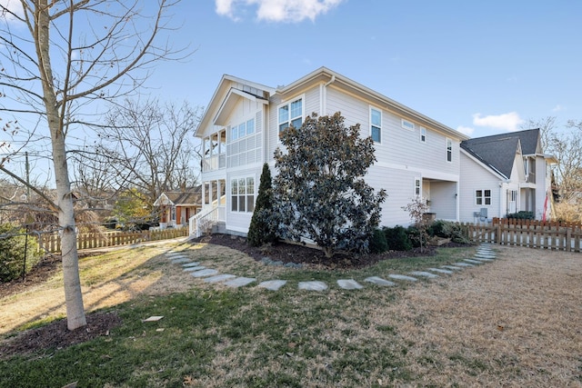 view of side of property with a yard and fence