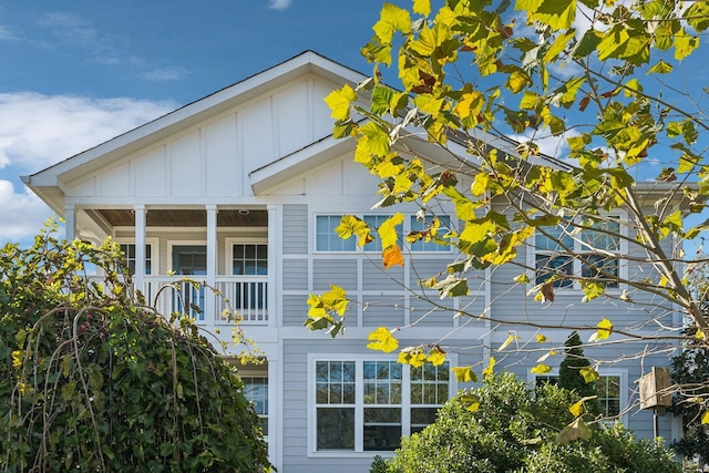 view of side of property with board and batten siding and a porch