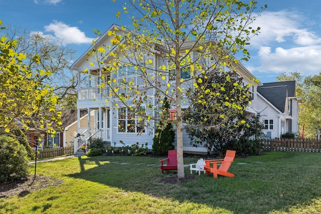 view of yard with fence and a balcony