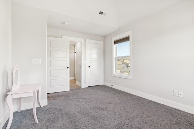 unfurnished bedroom featuring visible vents, baseboards, and carpet flooring