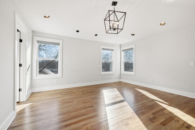 spare room with recessed lighting, light wood-style flooring, and baseboards