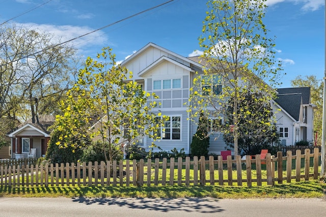 view of front of house with a fenced front yard and board and batten siding