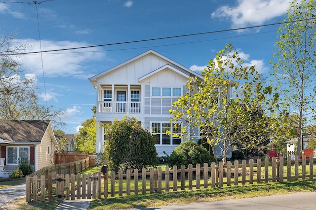 view of front of property with board and batten siding and a fenced front yard