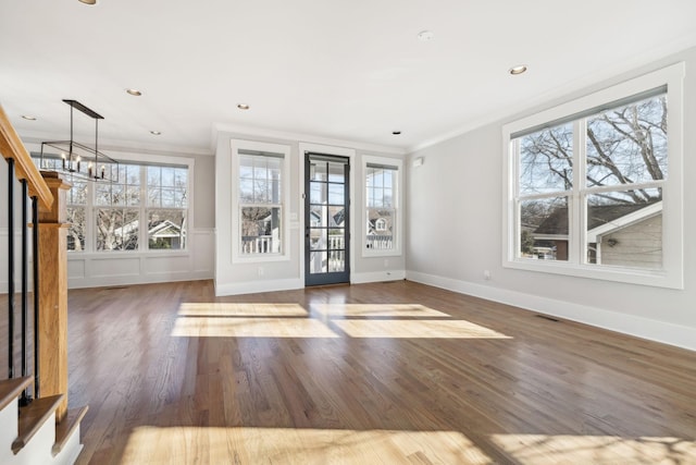 interior space featuring a notable chandelier, recessed lighting, wood finished floors, and crown molding