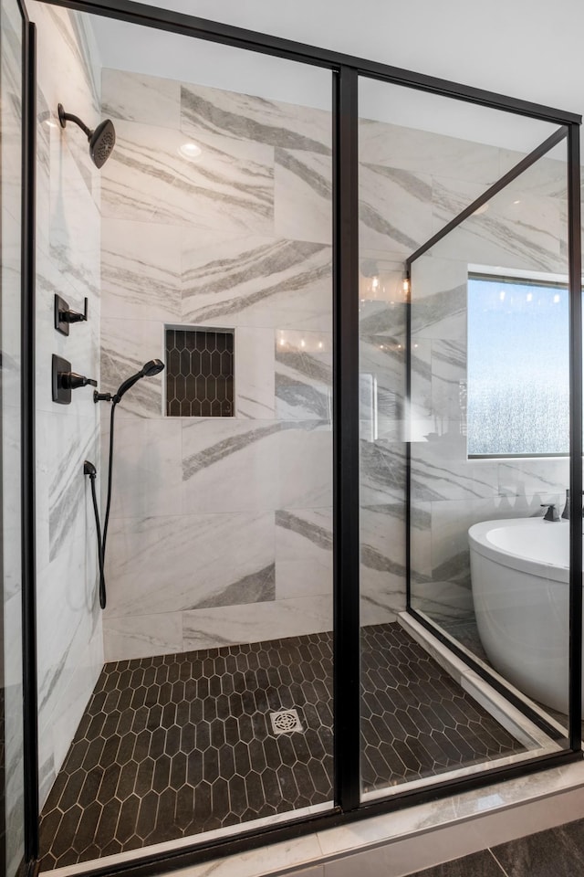 bathroom with a shower with door