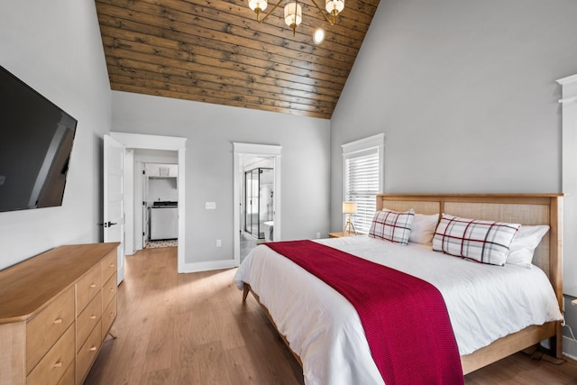 bedroom featuring ensuite bath, wood ceiling, a chandelier, light wood-type flooring, and high vaulted ceiling