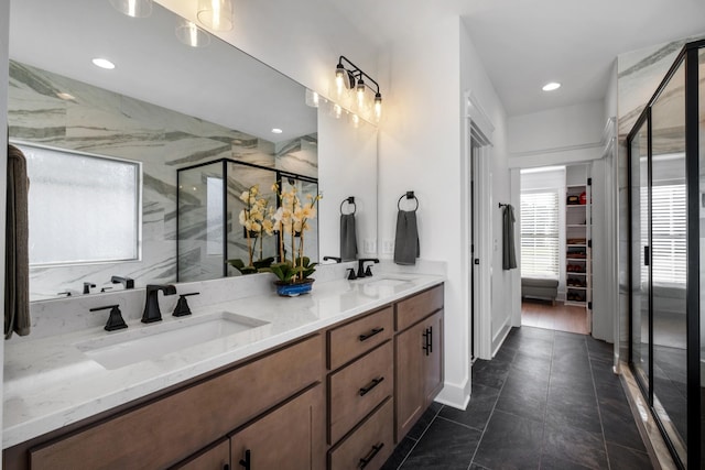 bathroom with walk in shower and vanity