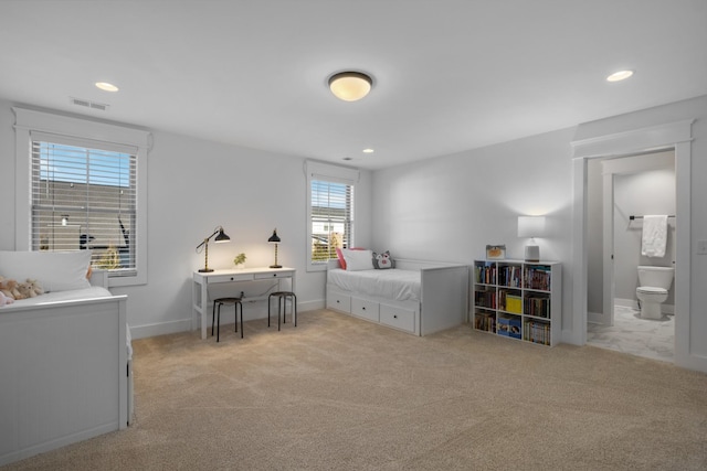 carpeted bedroom featuring connected bathroom