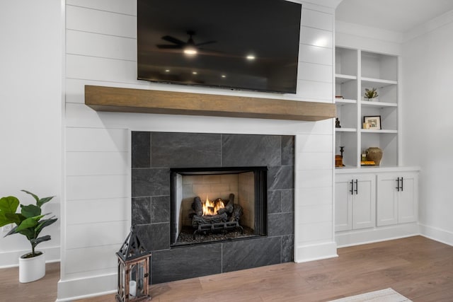 details with hardwood / wood-style flooring and a fireplace