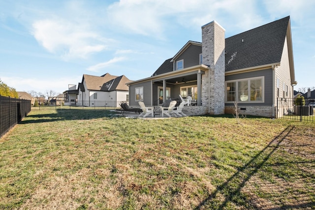 back of property with a patio and a yard