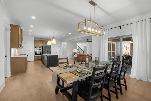 dining area with light hardwood / wood-style floors and ceiling fan