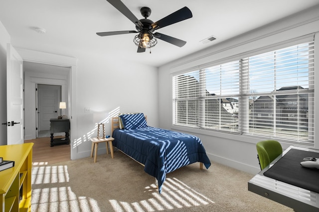 bedroom featuring ceiling fan and light carpet