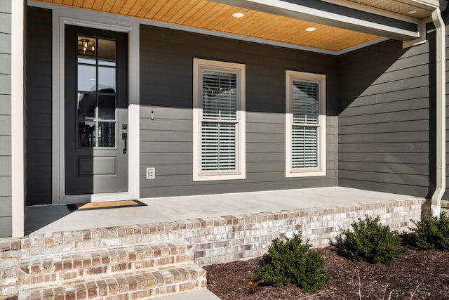 view of exterior entry with a porch