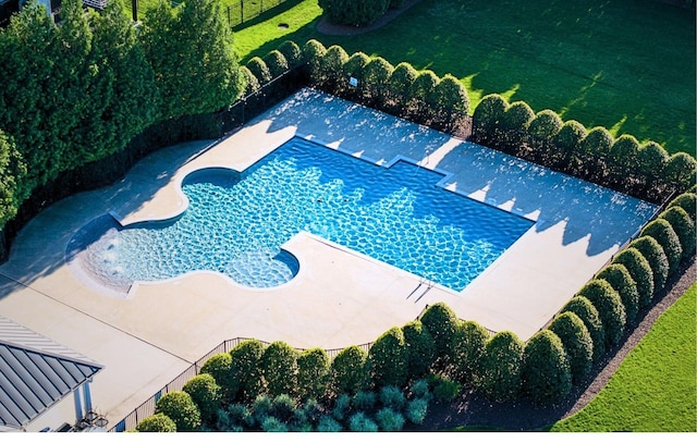 view of swimming pool with a patio and a lawn