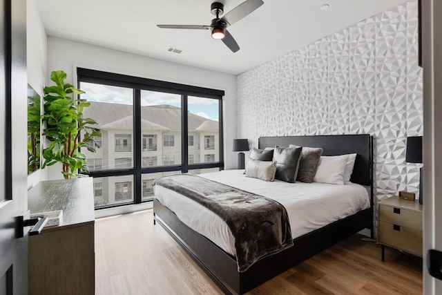 bedroom with wood-type flooring and ceiling fan