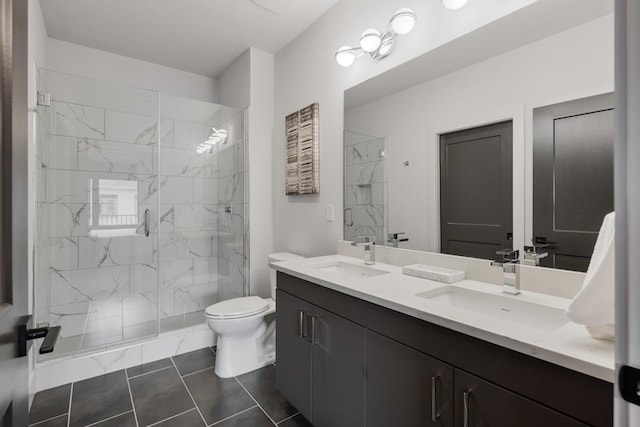 bathroom featuring a shower with shower door, tile patterned floors, vanity, and toilet