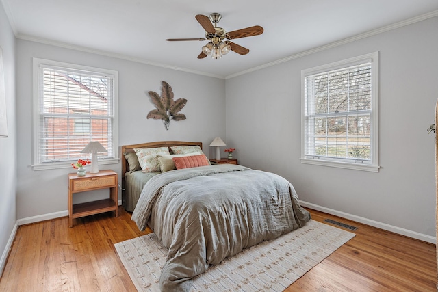 bedroom featuring light hardwood / wood-style flooring, ceiling fan, and ornamental molding