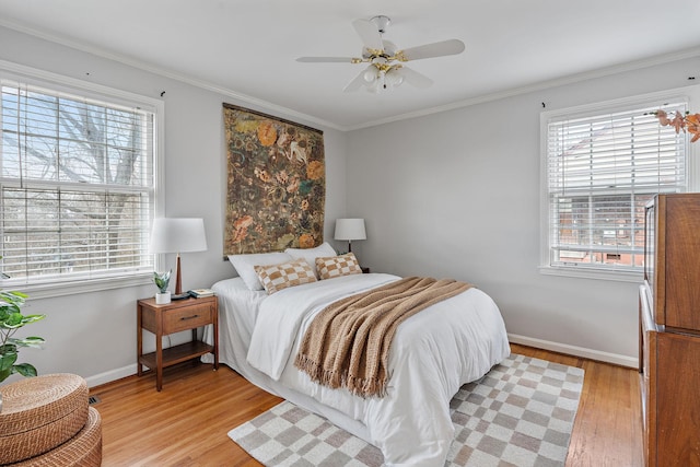 bedroom with ceiling fan, light hardwood / wood-style flooring, and crown molding