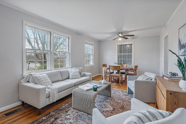 living room with ceiling fan, dark hardwood / wood-style floors, and ornamental molding